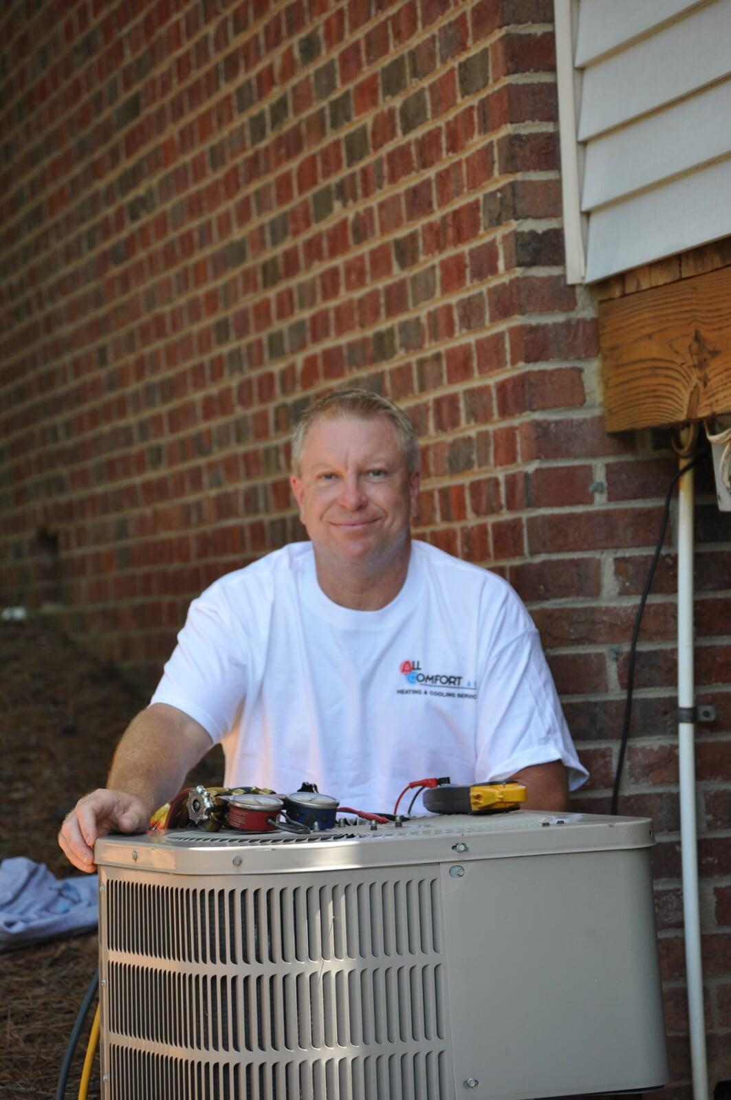 Darrell Howard, owner of All Comfort Air, beside the company’s Our Story section